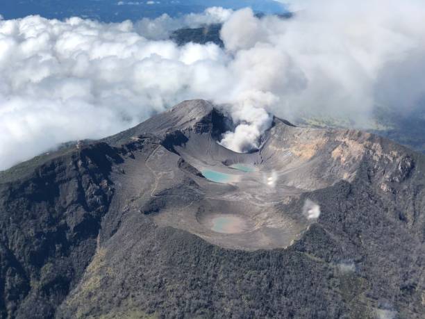 istock View of an active volcano with billowing clouds in the background 1489510773