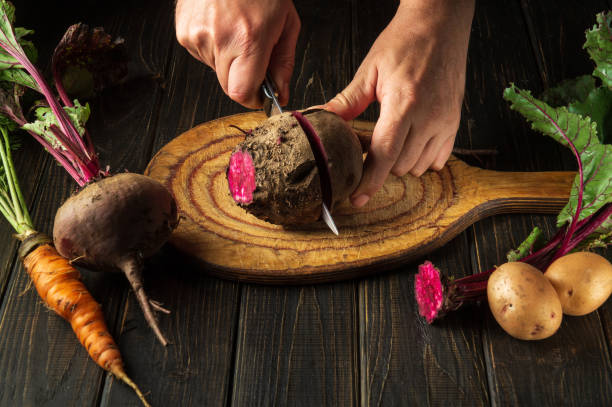 istock The chef cuts red beets or beetroot on a wooden cutting board. Peasant food 1489510788