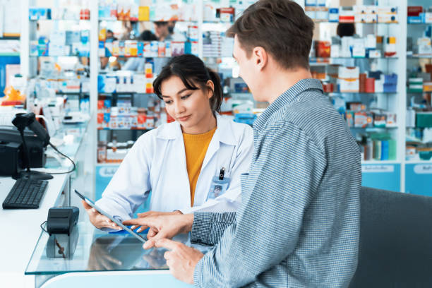 istock Caucasian customer purchases qualified prescription medication from pharmacist. 1489511455