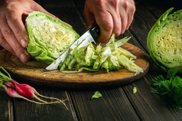 istock The chef cuts fresh cabbage with a knife on a cutting board before preparing a vegetarian dish 1489512077