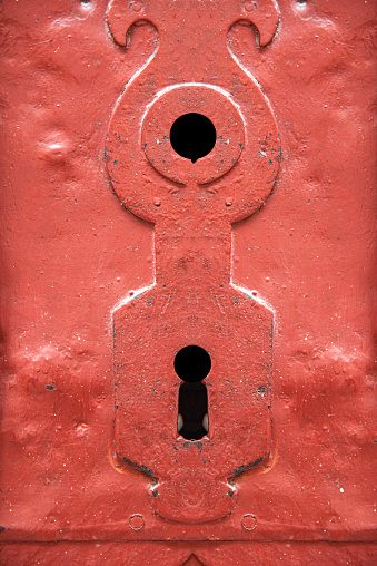 Antique keyhole close-up. Red old door.