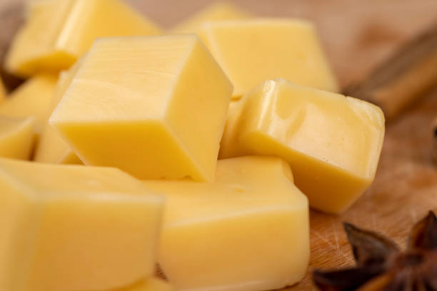 istock Yellow hard cheese sliced on a board 1489515006