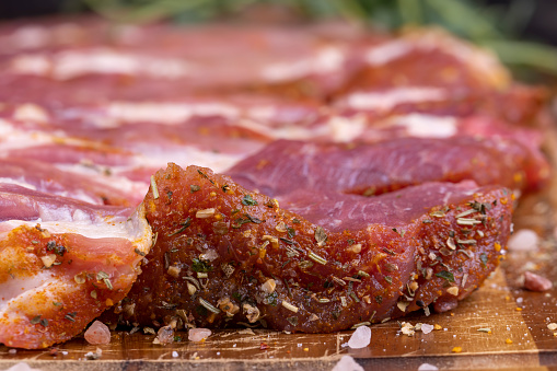 Pork meat pieces marinated with spices and salt, pork neck prepared for baking with mixed spices with sea salt