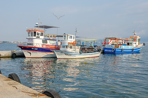Nessebar, Bulgaria - August 23,2014: Fishing boats in the bay against the background of the old town of Nessebar, Bulgaria.