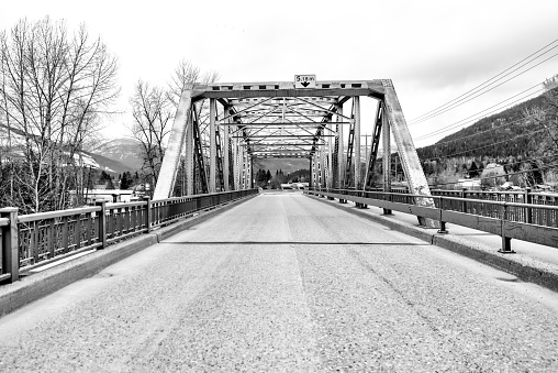 Revelstoke, British Columbia - April 15, 2023: A bridge over Illecillewaet River on the outskirts of downtown of Revelstoke