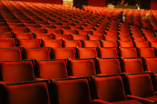 istock Velvety red chairs in a theater 1489519186