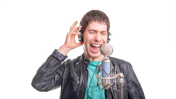 istock Male singer with microphone isolated on white background. 1489522973