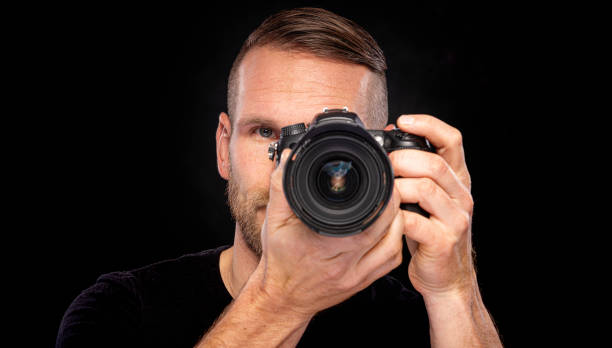 istock A man with a beard takes pictures with a camera. 1489523019
