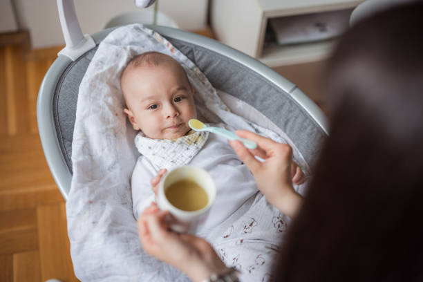 istock Baby resting in baby bouncer and eating smashed veggies 1489523355