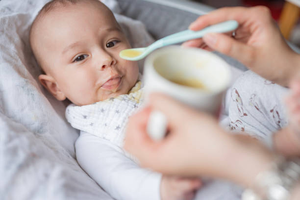 istock Baby resting in baby bouncer and eating smashed veggies 1489523378