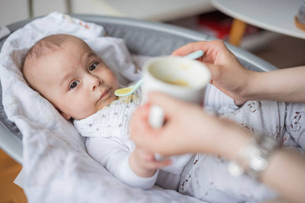 istock Baby resting in baby bouncer and eating smashed veggies 1489523440