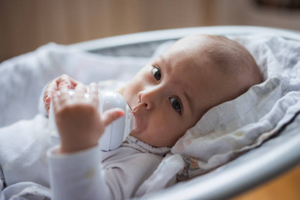 A baby bottle filled with Breast Milk isolated on a white background