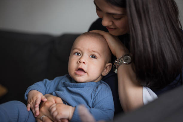 istock Mother sitting and holding the baby 1489523716