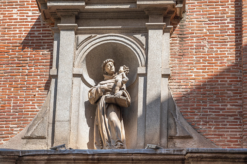 Madrid, Spain - Mar 23, 2019: Saint Anthony Statue in the facade of Church of Saint Anthony of the Germans (San Antonio de los Alemanes) - Madrid, Spain