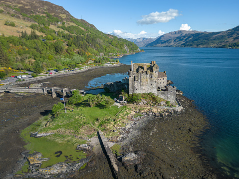 10th May 2023: Aerial drone view of Eilean Donan Castle, close to the Scottish Highland village of Dornie on the west coast of Scotland. The small tidal island has been occupied with a fortified building since the 13th century, first to defend against vikings, then later against feuding clan chiefs. An earlier castle, to the current one, was ruined during the Jacobite uprisings of the 17th & 18th century and left as a ruin for 200 years, with the current castle built on the ruins and completed in 1932.