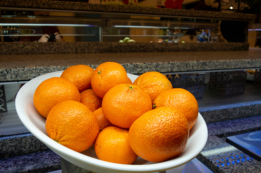 Stack of fresh and juicy naval oranges isolated in white