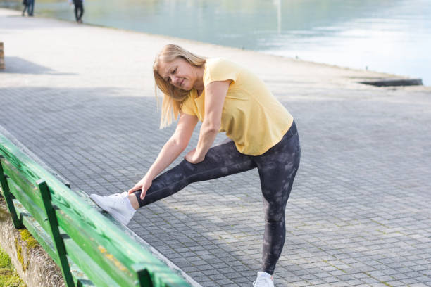 istock mature woman warming up for running 1489531324