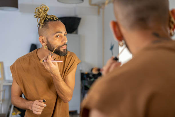 Black male gay applying make up