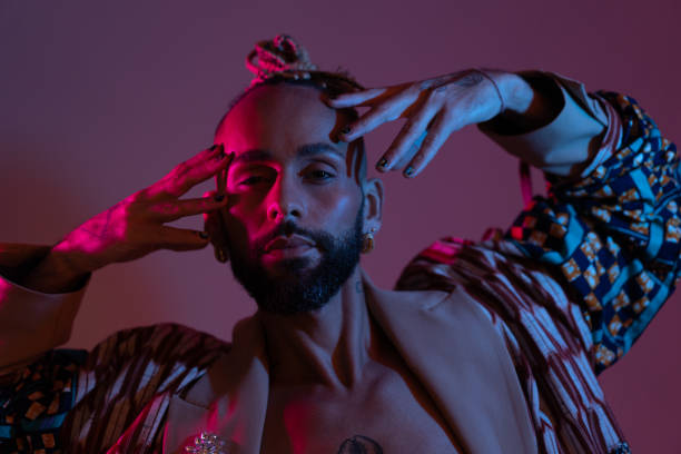 istock Neon light studio close-up portrait handsome black gay man looking camera. 1489532008