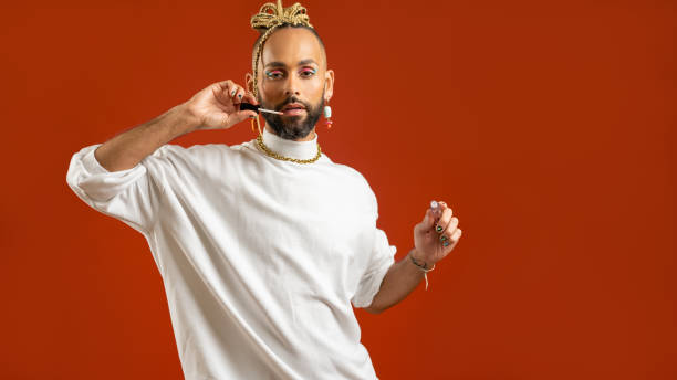 istock African american gay applying make up isolated on red background 1489532135