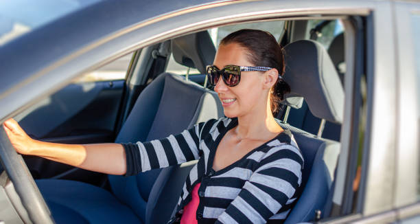 istock Beautiful young woman driving a car. 1489535062