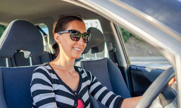 istock Beautiful young woman driving a car. 1489535071