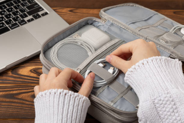 istock Using a holder for storing and transporting wires. Wires of modern electronic equipment in a convenient storage bag. Preparing for a business trip or vacation. Packing method and technological tools. 1489536739