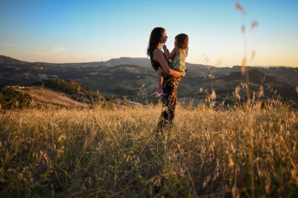 istock Mother with child explore mountains at sunset. Love and parenthood. 1489538814