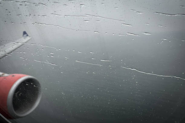 defocused-view-on-airplane-wing-through-passenger-window-with-rain-drops.jpg