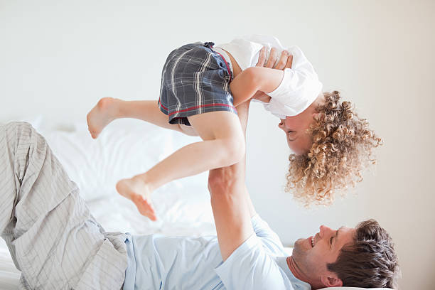 istock Side view of smiling father lifting child 148955108