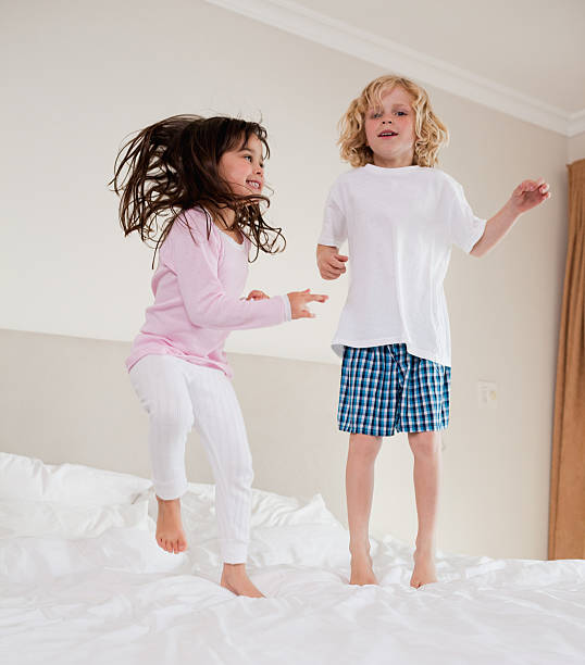 istock Portrait of siblings jumping 148955123