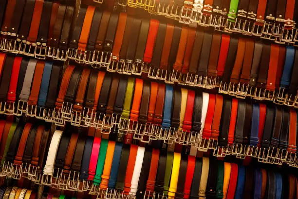Photo of Florence, Italy - March 27, 2023: The row of belts leather at the Florence street market.