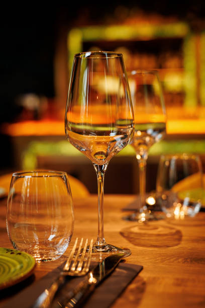 istock Clear wine glasses on the wooden table in restaurant. 1489556936