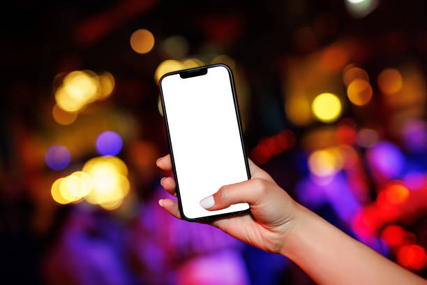 istock Smartphone mockup with a white blank screen at a party. 1489556952