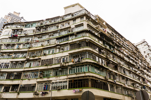 Hong Kong - December 2019 : White Tenement Houses, Old Residential Buildings in Tai Kok Tsui, Hong Kong, Low Angle View