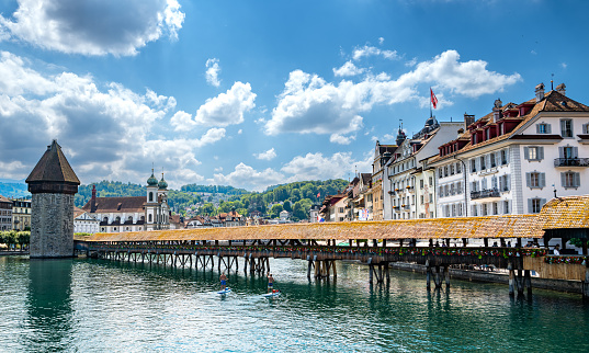 Lucerne, Switzerland - July 10, 2022: View of the Chapel Bridge in historic city of Lucerne,  Switzerland.  One of the main tourist attractions in the city center.
