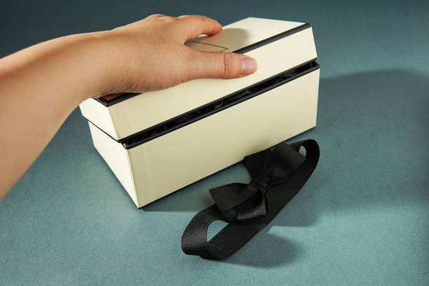 istock Hand holding a gift box against green background. 1489577989