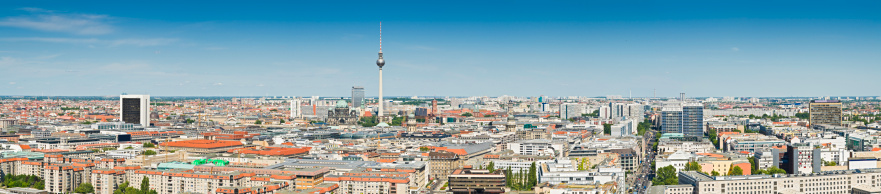 Clear blue panoramic skies over the rootops, avenues, landmarks and districts of Berlin, from the green dome of the Berliner Dom, the elegant Soviet-era spire of the Fernsehturm, the stra