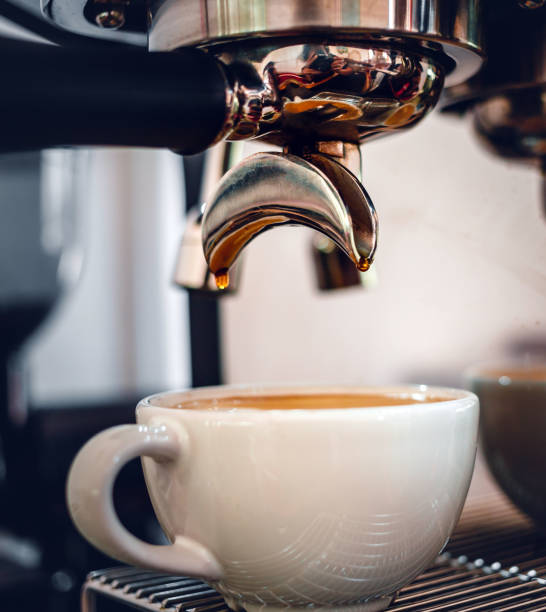 istock Espresso coffee extraction from a professional coffee machine with a bottomless filter, Close-up of a coffee drop  from the coffee machine 1489579546