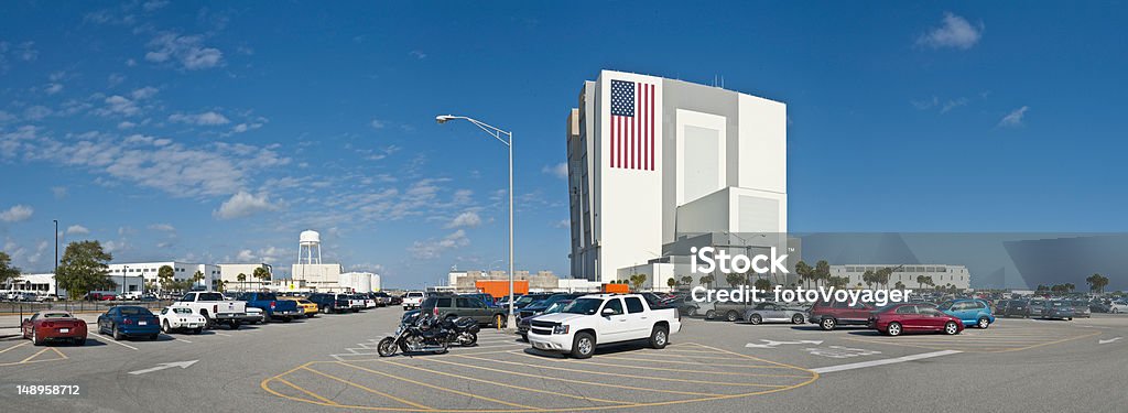 Vehicle Assembley Building Cape Canaveral Big blue panoramic Florida skies over the Vehicle Assembly Building at the NASA Kennedy Space Center, Cape Canaveral. The world's largest single storey building, the VAB can be seen for miles around across the flat landscape of the Atlantic coast. The two doors on the left were for the exit of the Saturn V Apollo rockets, whilst the Shuttle on its crawler transporter exits vertically on the right toward the launch pads several miles away. ProPhoto RGB profile for maximum color fidelity and gamut. NASA Kennedy Space Center Stock Photo