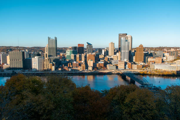 Skyline of downtown Pittsburgh Pennsylvania USA with reflections in the Monongahela River at night.