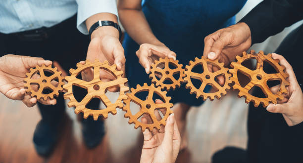 istock Office worker holding cog wheel as unity and teamwork in workplace. Concord 1489589725