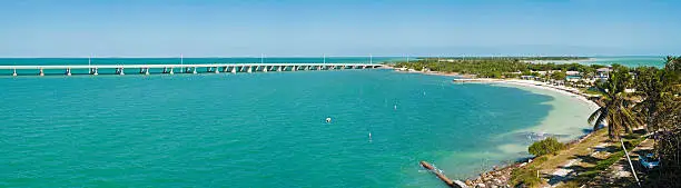 The idyllic white sand beaches, palm trees and shore of the Bahia-Honda State Park in the Lower Keys of Florida and the Overseas Highway stretches from island to island across turquoise tropical oceans. ProPhoto RGB profile for maximum color fidelity and gamut.