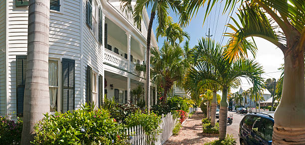 street with colourful painted wooden townhouses with white fence Key West Florida USA