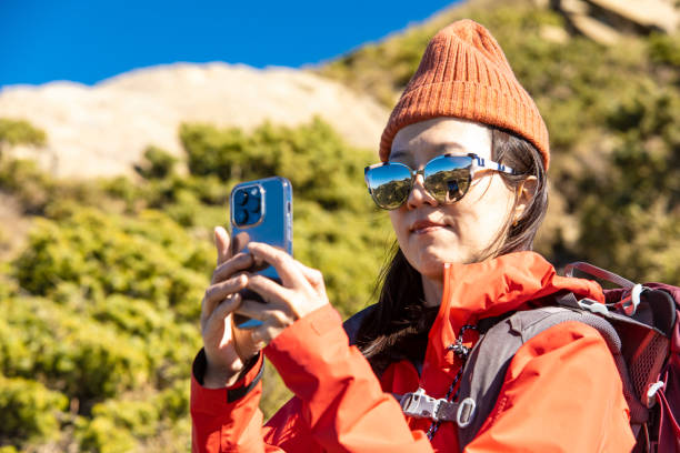 istock Mountain hiker using Ssmart phone on the mountain top. 1489601386