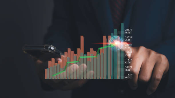 istock Stock market graph with man working on computer stock trading screen. 1489603291