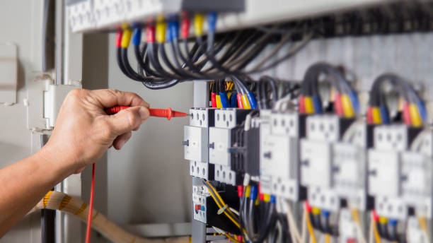 istock Electrical engineer checking the operation of electrical control cabinet, maintenance concept. 1489608888