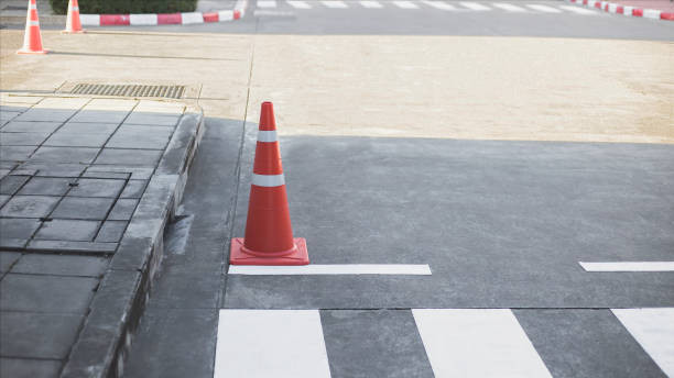 istock Orange traffic cones on cement road surface. 1489608995