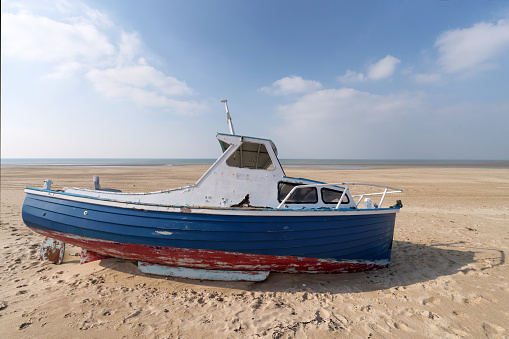 Low tide and old abandoned boat in the Cotentin coast. The havre of Saint-Germain-sur-Ay