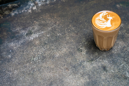 Hot latte art coffee on cement background aroma coffee drink